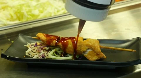 Sauce on a skewer fried fish Stock Footage 40696269