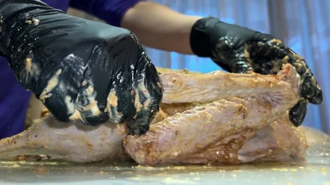 Sauce is spread with the hands on the ready-to-cook goose Video stock 221271454