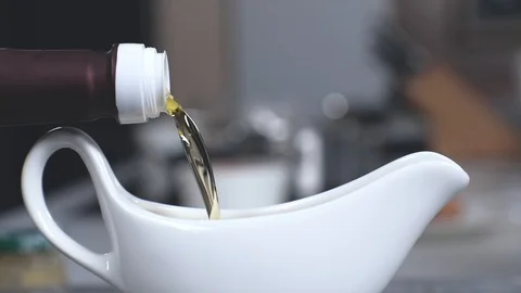 In sauceboat pour olive oil Stock Footage