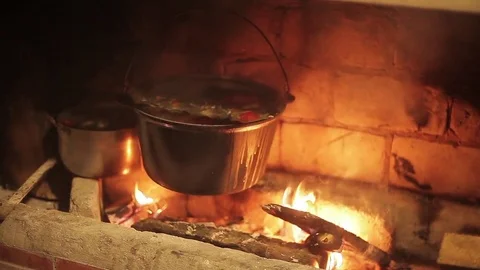  saucepan with fish soup cooked on fire on the grill.cauldron at the stake. Stock Footage 71944602