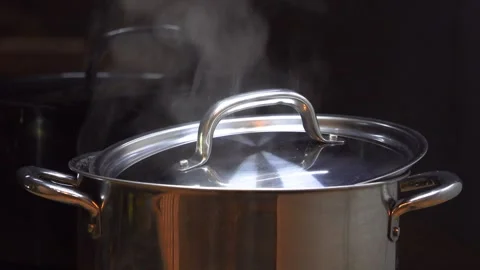 Saucepan standing on the stove in which water is boiling Stock Footage 281261009