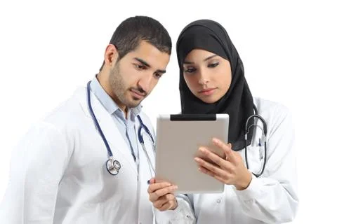 Saudi arab doctors working with a tablet Stock Photos