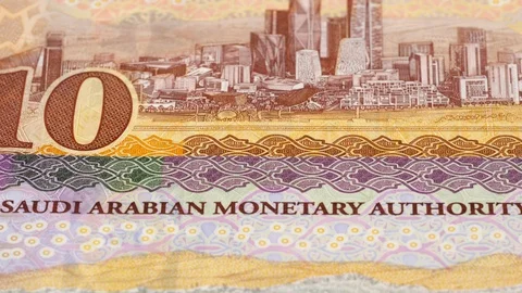 Saudi Arabia riyal banknotes tracking. Slider shot, low angle. 4K Stock Footage 125987013