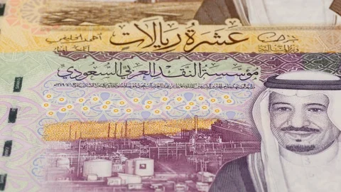 Saudi Arabia riyal banknotes tracking. Slider shot, low angle. 4K Stock Footage 125987304