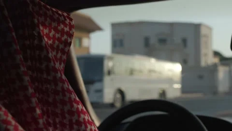 Saudi man inside the car, driving around the city wearing the traditional 動画素材 162024830