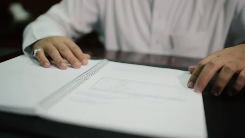 Saudi man reading contract 2 Stock Footage 112949755