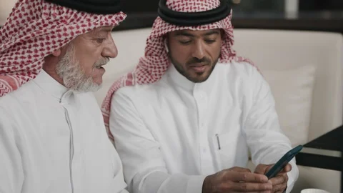 Saudi men using a smartphone Stock Footage 105803781