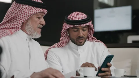 Saudi men using a smartphone Stock Footage 105803810