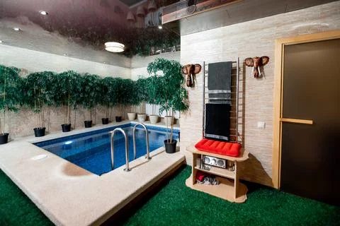 Sauna pool. Small pool with red bench and mirror Stock Photos
