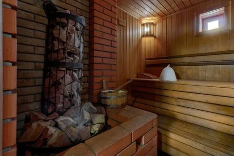Sauna steam bath inside with stones and stove Illustrazione stock