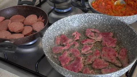 Sausage and beef cutlet cooked in a pan on the stove, breakfast preparation,  스톡 동영상 201268241