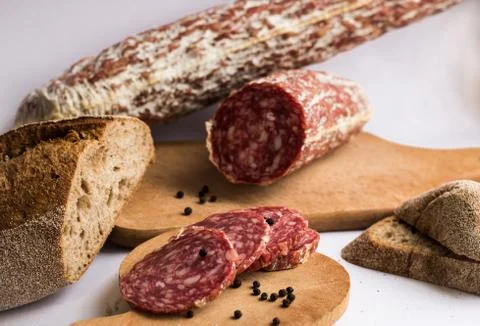 Sausage and bread on white background Stock Photos