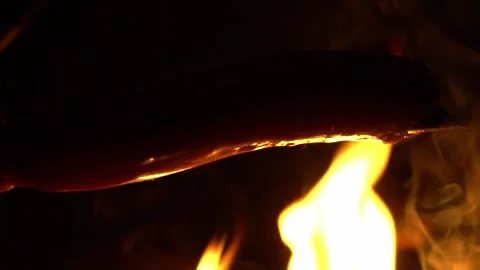 Sausage on the background of fire Видео 136423080