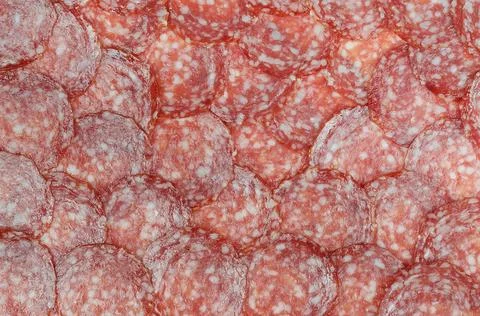 Sausage background (texture, pattern) from sausage slices. Stock Photos