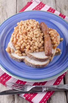 Sausage with baked beans on bread Stock Photos