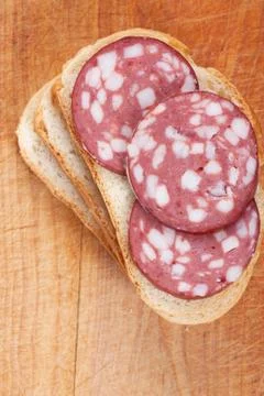 Sausage on a bread Stock Photos