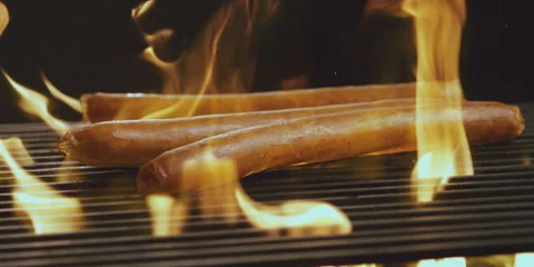 Sausage falling onto the grill Video stock 247386608