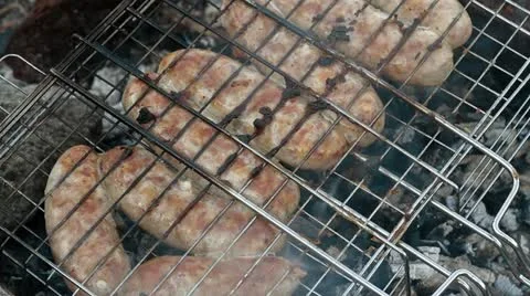 Sausage is fried on nature Stock Footage 10875336