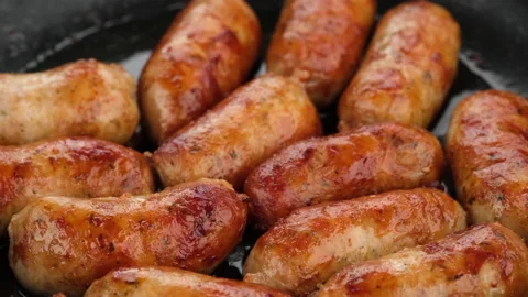 Sausage fried on pan, close up Stock Footage 138355386