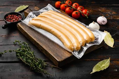 Sausage for hot dog, on old dark wooden table background Stock Photos