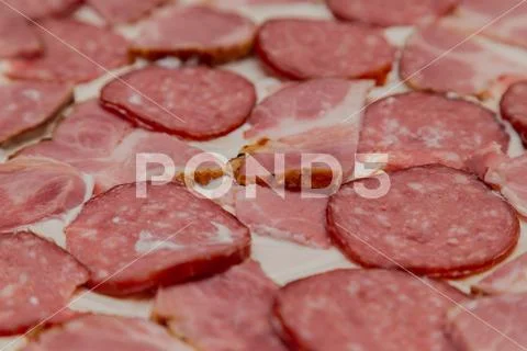 Sausage with meat on dough with mayonnaise and cheese, pizza preparation Stock Photos