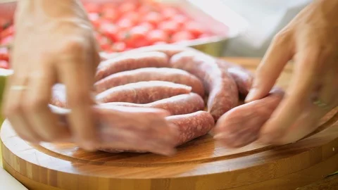 Sausage preparation for bbq Stock Footage 93512207