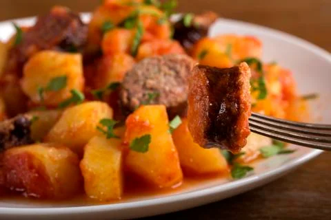 On sausage slice in fork Stock Photos