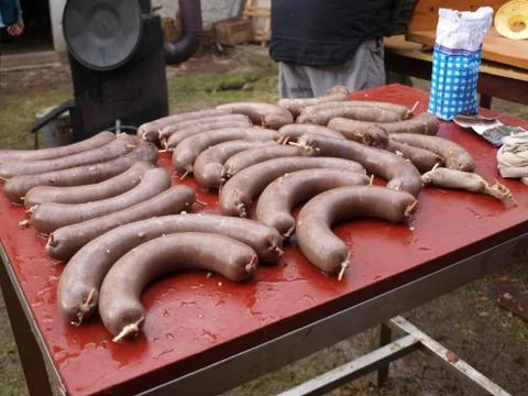 Sausage on a table, white pudding ready to eat, home pig slaughter Stock Photos