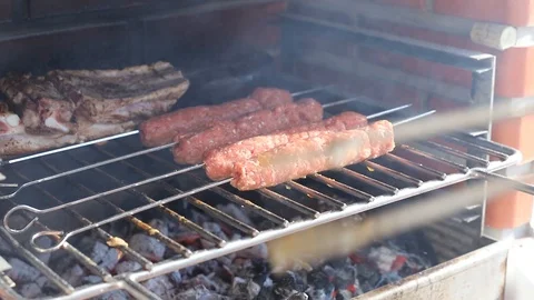 Sausages and meat preparing on the grill Video stock 114612480