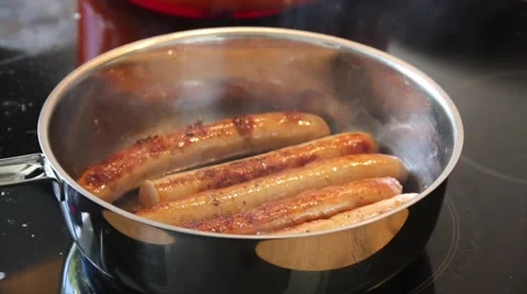 Sausages baking in a pan Stock Footage 62528870