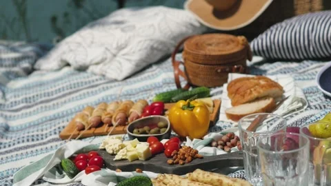 Sausages, bread, vegetables on a blanket. summer picnic in nature 動画素材 147372203