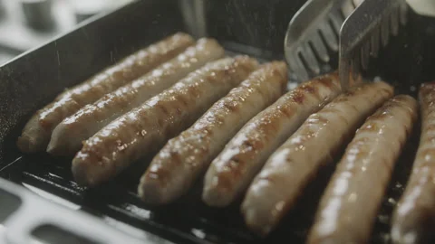 Sausages Chef Checking Roast and Turn Closeup Stock Footage 159330113
