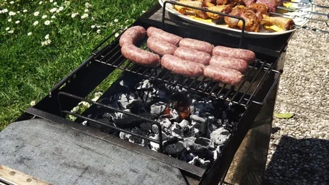 Sausages, chicken and beef getting cooked for summer barbecue, 4K Stock Footage 74655744