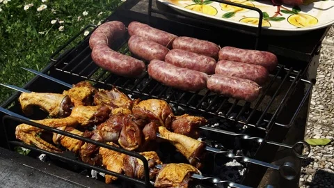 Sausages, chicken and beef getting cooked for summer barbecue, slow moti Stock-Footage 74655940