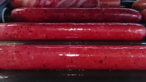 Sausages cooking on an automatic electro barbecue grill Stock Footage 173869242