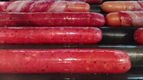 Sausages cooking on an automatic electro barbecue grill Stock Footage 173869244