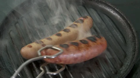 Sausages cooking Stock Footage 112589784