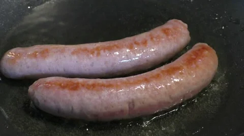 Sausages cooking in the pan Stock Footage 46000752