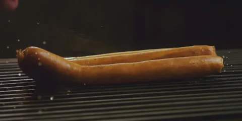 Sausages fall on the grill Stock Footage 247386594