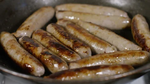 Sausages in a frying pan cooking  Stock Footage 59215055