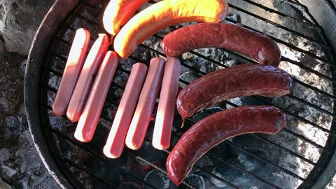 Sausages in the grill in the evening light, handheld shot Stock Footage 168330475