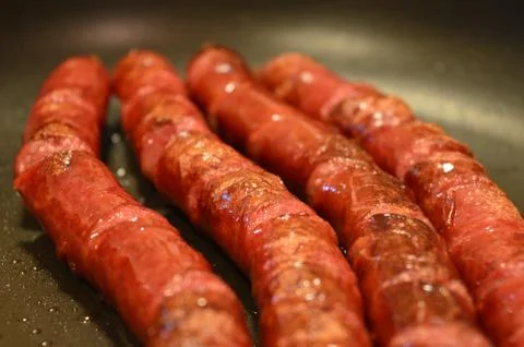 Sausages on a grill Stock Photos