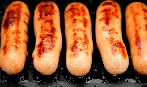 Sausages on a grill Stock Photos