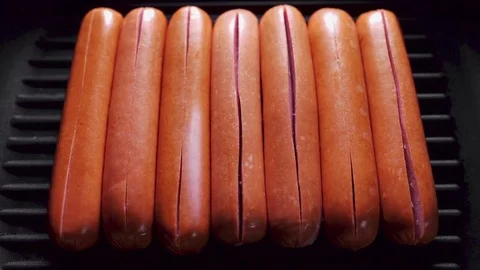 Sausages opens on the frying pan because of temperature, roasted crispy sausages Stock Footage 76937946