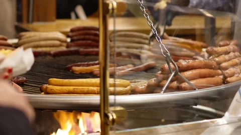 Sausages Roasting Over Open Fire at Paris Christmas Market Stock Footage 307012280