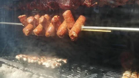 Sausages rotating on the grill Stock Footage 198910175