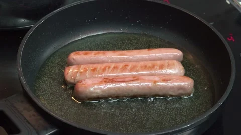 Sausages while frying in pan, close-up Stock Footage 141845013
