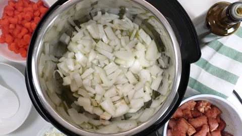 Saute chopped onion in a multi cooker. Cooking rice with meat and vegetables  Stock-Footage 131571592