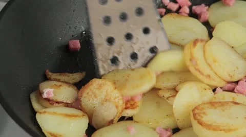 Saute potatoes with lardons in a frying pan Stock Footage 24667853