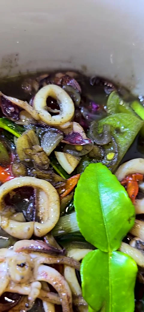 Sauteed squid with black ink sauce with spicy seasoning called Tumis Cumi H.. Stock Footage 279727634